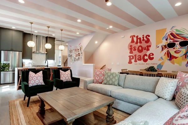 Themed Nashville living room with pink striped ceiling, Taylor Swift mural, and eclectic decor