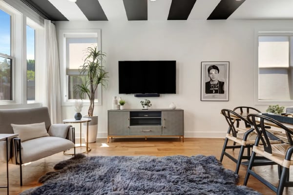 Bright Nashville living room with black beam ceiling, large windows, and modern furnishings