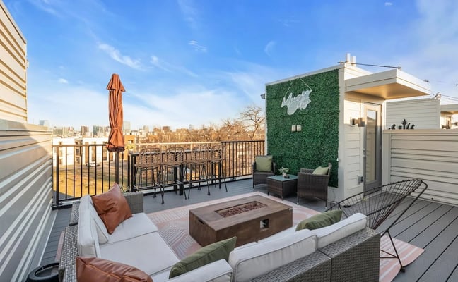 Rooftop terrace with seating area, fire pit, and Nashville city skyline view